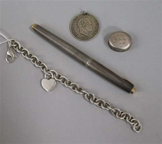 A sterling silver Parker pen, a Tiffany and Co silver bracelet, pill box and a George III coin pendant.